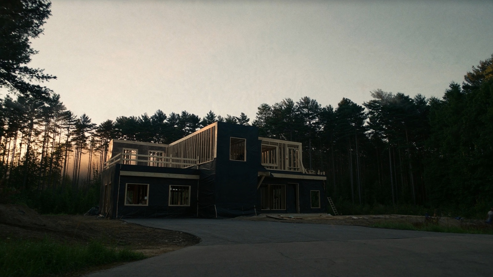 Custom home under construction at golden hour in the Adirondack foothills