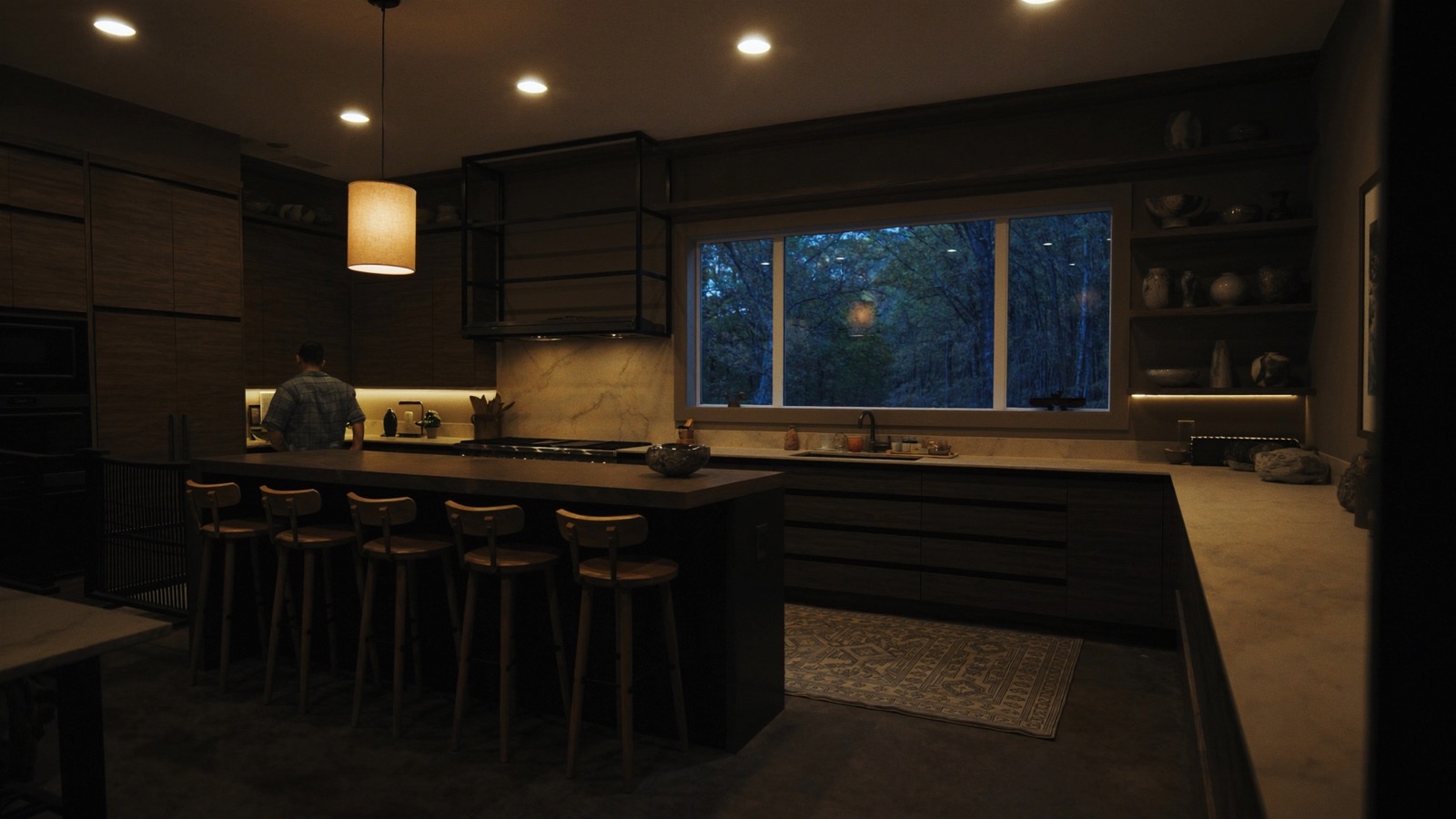 Finished custom kitchen with warm recessed and under-cabinet lighting at dusk
